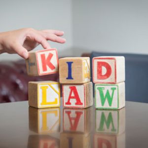wooden blocks that spell out Kid Law