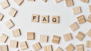 wooden tiles with FAQ spelled out as Scrabble tiles