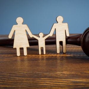wooden cutouts of two parents holding child's hand