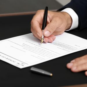 a hand writing on a legal document