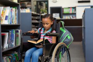 child using wheelchair at a library