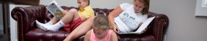 kids reading together on couch
